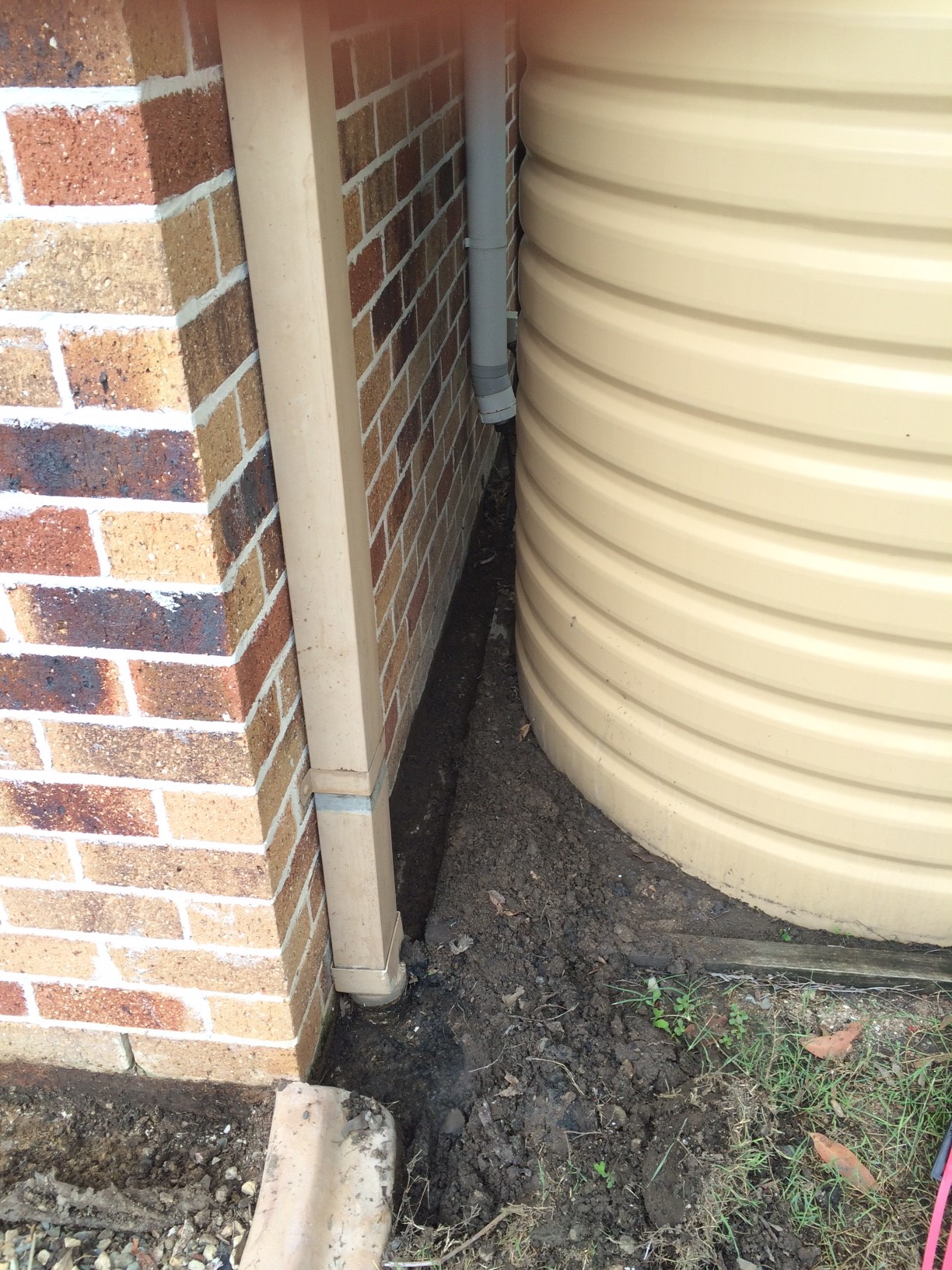 Termite barrier preparation behind a water tank